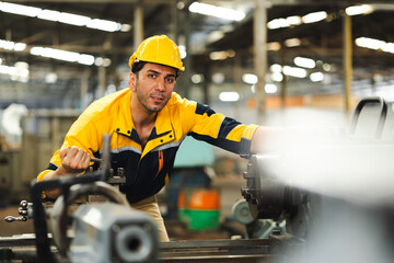 Working : Hispanic latin male worker. Professional Mechanical Engineer worker wearing safety hard hat helmet Working at Heavy industrial manufacturing factory. Engineer Operating Machinery