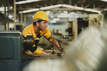 Working : Hispanic latin male worker. Professional Mechanical Engineer worker wearing safety hard hat helmet Working at Heavy industrial manufacturing factory. Engineer Operating Machinery