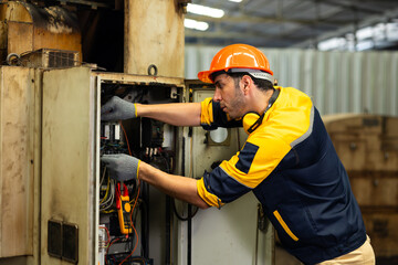 Working : Hispanic latin male worker. Professional Mechanical Engineer worker wearing safety hard hat helmet Working at Heavy industrial manufacturing factory. Engineer Operating Machinery