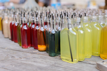 Colorful Glass Bottles with Refreshing Drinks at Outdoor Market