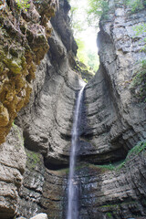 View of a waterfall and wet rock in Chegem Gorge