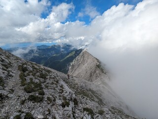 Panoramic view of Logarska dolina valley with peaks of Slovenian Alps covered by passing clouds.