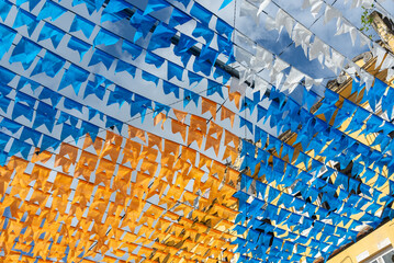 Decoration of the June festival with colorful flags. Plastic objects attached to the top.