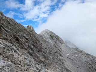 Panoramic view of Logarska dolina valley with peaks of Slovenian Alps covered by passing clouds.