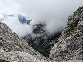 Panoramic view of Logarska dolina valley with peaks of Slovenian Alps covered by passing clouds.