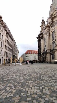 Panning across neumarkt square, showing the cobblestones and the frauenkirche vertical footage