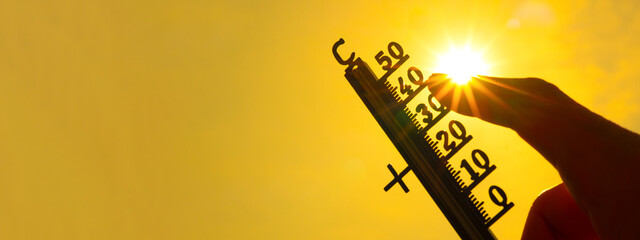 Hot weather, global climate change concept - Heat wave / Summer heat temperature celsius background banner long - Thermometer yellow orange sky and sun rays