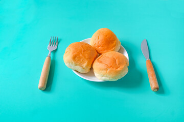 Fresh buns in baking dish on table.
