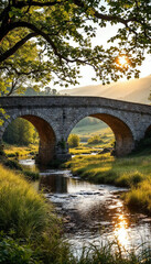 Sunlit historic stone bridge spans a tranquil river amid lush greenery.









