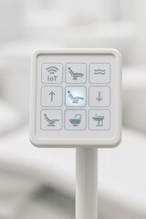 IoT dental chair control panel with one button design in modern clinic setting