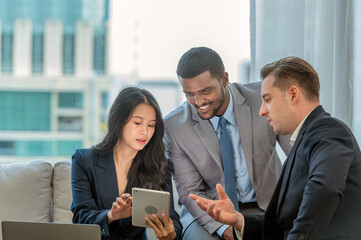A diverse group of business professionals having a meeting in a modern office space.