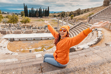 Tourist admiring the ancient Asklepion Theatre in Pergamon, Turkey, a world heritage site, showing its well preserved stage and seating area