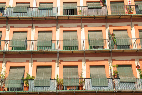 Mediterranean Building Facade with Balconies and Green Blinds &ndash; Urban Residential Architecture