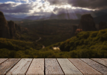 Wooden table top on blur  field and mountain background in daytime.Harvest rice or whole wheat.For montage product display or design key visual layout.View of copy space.