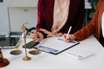 Business and lawyers discussing contract papers with brass scale on desk in office. Law, legal...