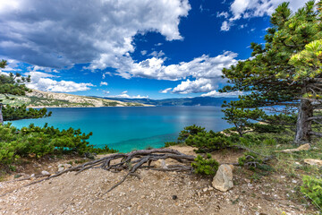Hiking trail leading from the beach in Baska to the Bag mountain, city panorama seen from above,