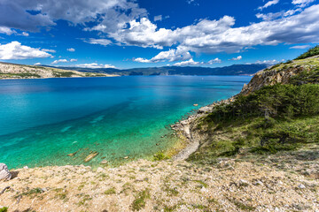 Hiking trail leading from the beach in Baska to the Bag mountain, city panorama seen from above,