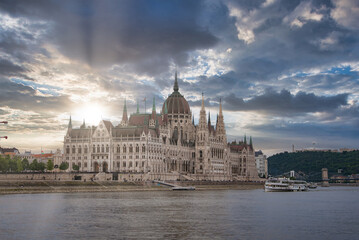 The neo Gothic Hungarian Parliament Building stands by the Danube River in Budapest, with a boat on...