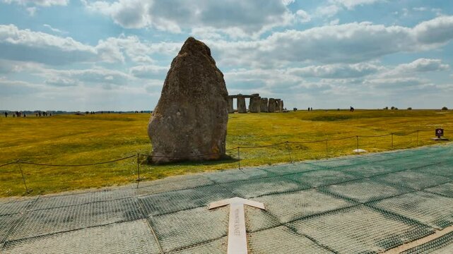 The elliptical formation of upright stones and lintels perched on windswept pastures under a sweeping sky, Stonehenge, Salisbury, Wiltshire, England, UK
