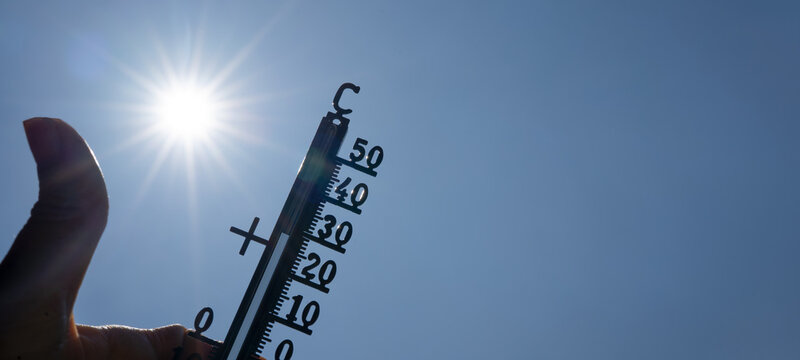 Hot weather, global climate change concept - Heat wave / Summer heat temperature celsius background banner long - Thermometer blue sky and sun rays