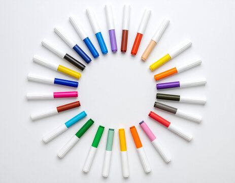 colorful markers on a white background in a circle shape