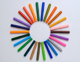 colorful markers on a white background in a circle shape
