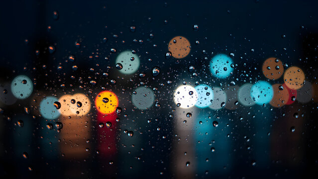 Rain Drops on Glass Window Night City Lights Reflection Abstract Background