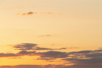 A truly serene view of a breathtaking sunset sky, showcasing beautifully soft clouds that stand out...