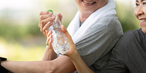 Couple sharing water and smiles during fitness session