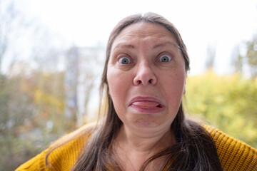 open-mouthed middle-aged woman in shock, capturing raw emotion surprise and disbelief unexpected news, Mature woman Emotional portrait