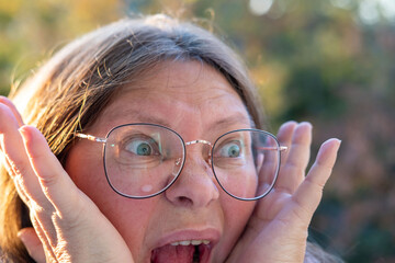 Close-up middle-aged woman with shocked and astonished expression, wide eyes and open mouth reveal deep surprise, emotional dramatic portrait