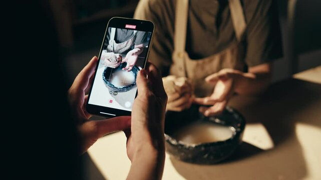 Woman makink video with phone screen and person with photo of clay design for e commerce market, online post. Workshop, creative and picture of ceramic bowl for social media for hobby