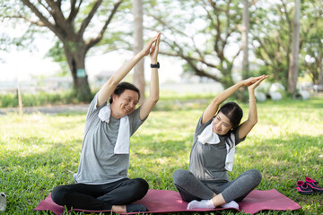 Couple enjoying outdoor yoga stretches in a park