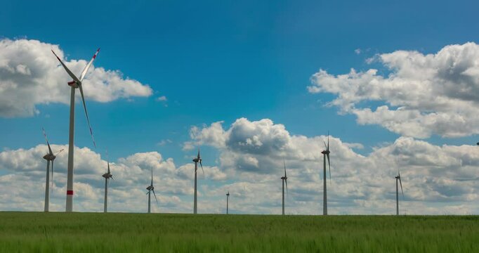 Time-lapse footage of modern wind turbines spinning over vibrant green fields in rural Germany. A powerful symbol of the Energiewende and Germany&rsquo;s response to climate change and energy transition