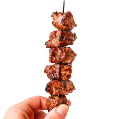 Succulent meat cubes on a skewer, grilled to perfection. A handheld culinary delight, ready to be enjoyed. Isolated on black.