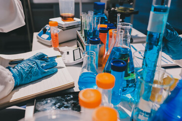 Scientist pipetting medical samples into microplate in laboratory