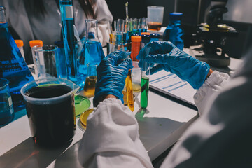 Scientist pipetting medical samples into microplate in laboratory