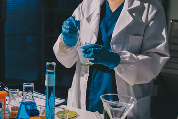 Scientist pipetting medical samples into microplate in laboratory
