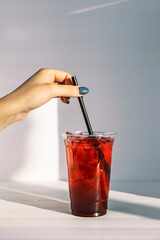 hand holding a glass of lemonade