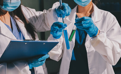 Scientist pipetting medical samples into microplate in laboratory