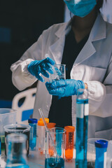 Scientist pipetting medical samples into microplate in laboratory