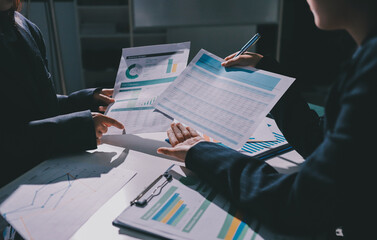 Group of business women working on a financial data expenses document.