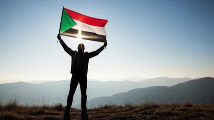 Silhouette of Man Holding Sudanese Flag Atop Mountain Range at Sunrise