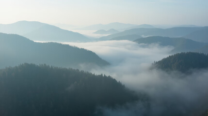 Misty mountains landscape with fog covering valleys, creating serene and tranquil atmosphere. soft hues of blue and gray enhance peaceful scenery