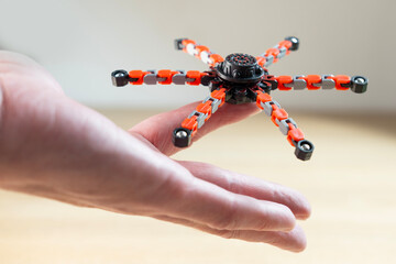Spinner in male hand, stress relief, useful for people who are recovering from arm injury or suffer from tremors, develop fine motor skills