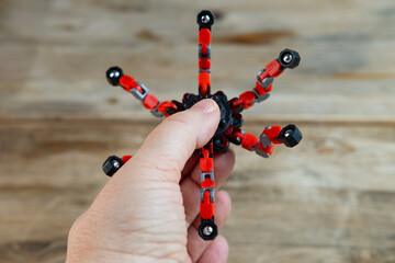 Spinner in female hand, stress relief for people who suffer from anxiety, panic attacks, attention deficit disorder, substitute bad habits, hair twisting