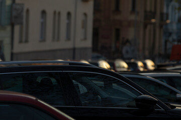A picturesque view of multiple parked cars in a bustling urban setting during the enchanting twilight hours, showcasing a diverse array of vehicles along with the surrounding buildings
