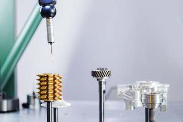 Cnc coordinate measuring machine inspecting precision gear with probe in industrial setting,...