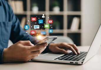Person using smartphone and laptop with social media icons displayed