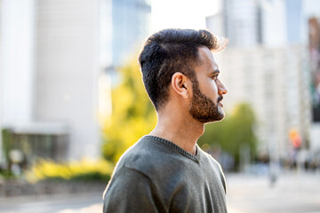 Portrait of a handsome young man with beard in the city 
